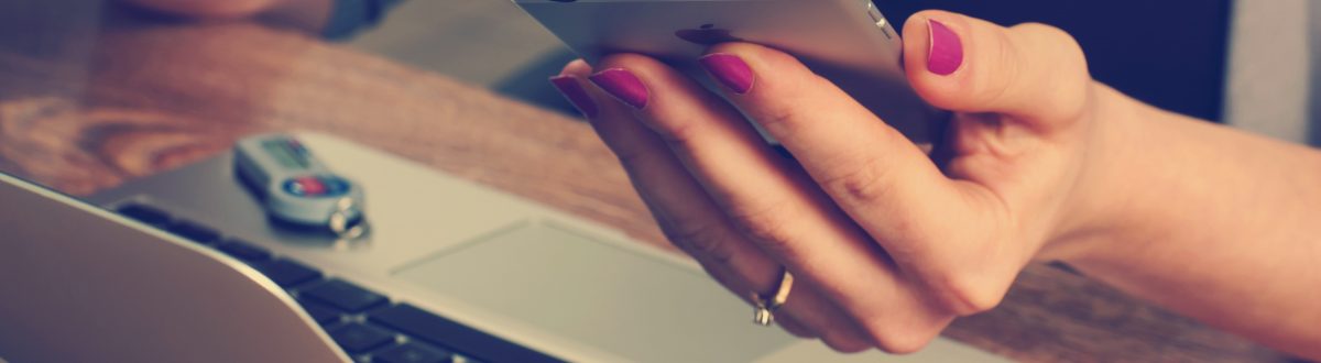 Image of woman with smartphone and laptop